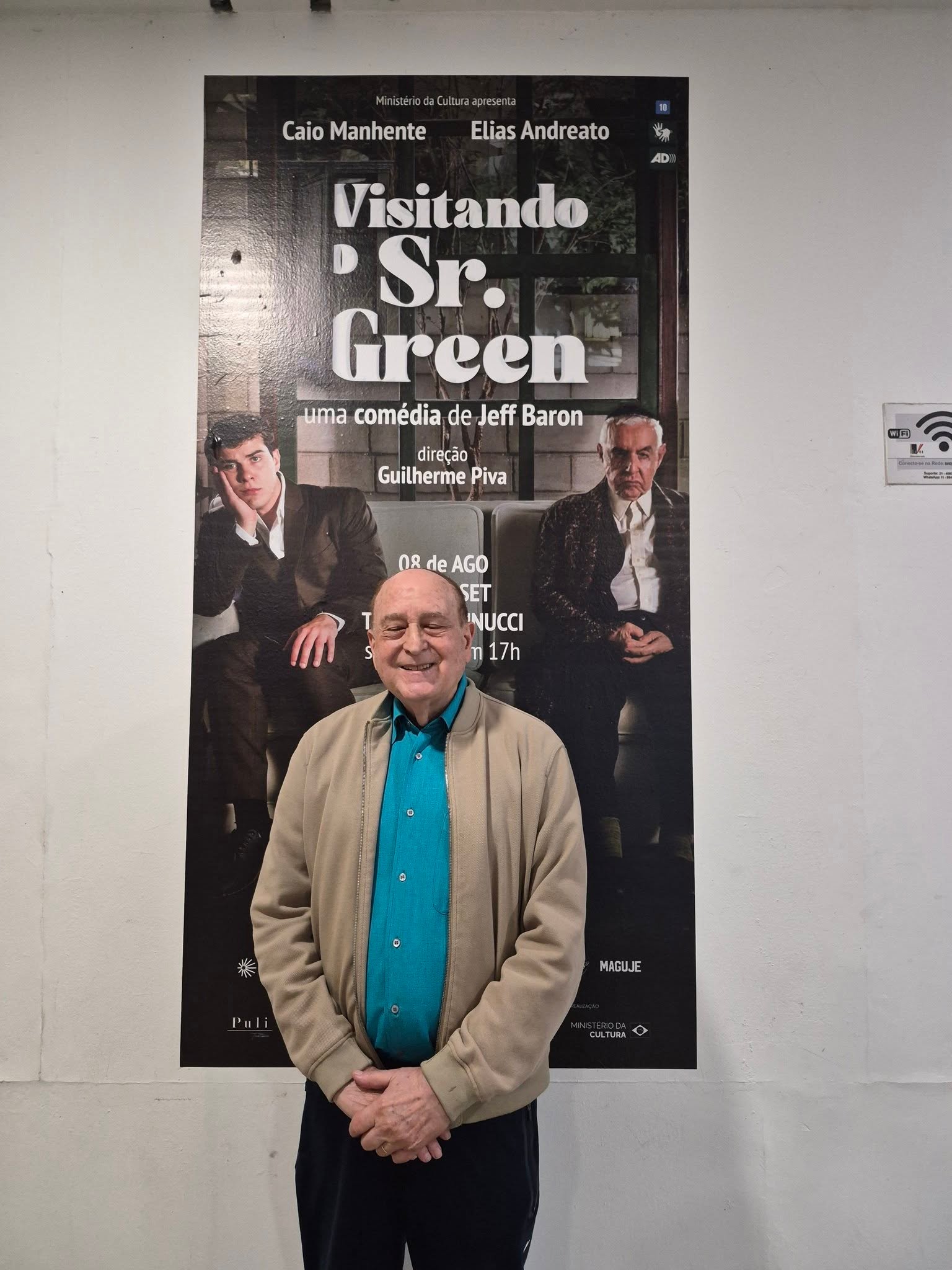 Harold Emert in front of a Visiting Mr. Green poster at Teatro Vannucci